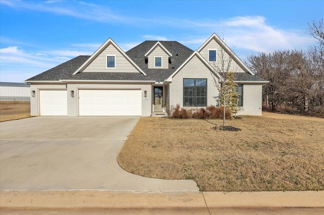 view of front of home with a garage and a front lawn