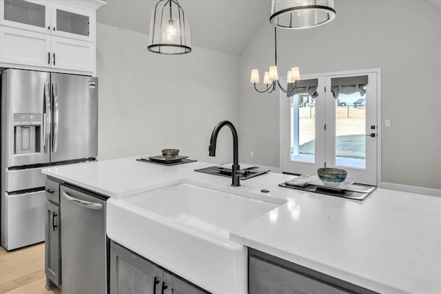 kitchen with white cabinetry, sink, pendant lighting, and appliances with stainless steel finishes