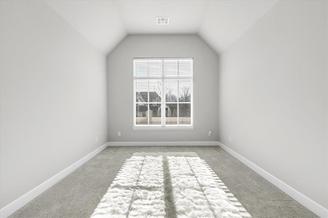 additional living space with light colored carpet and lofted ceiling