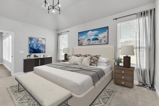 carpeted bedroom with lofted ceiling, multiple windows, and a chandelier