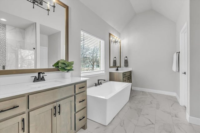 bathroom with vanity, lofted ceiling, and a bath