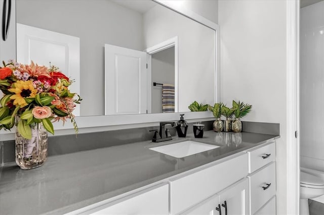 bathroom with vanity, toilet, and walk in shower