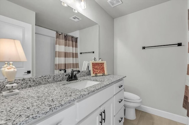 bathroom with curtained shower, hardwood / wood-style floors, vanity, and toilet