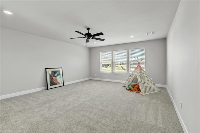 game room featuring ceiling fan and light colored carpet