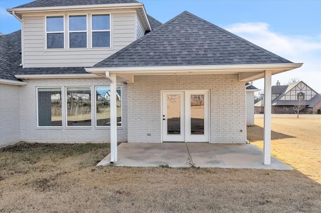 back of property with a patio area and a lawn