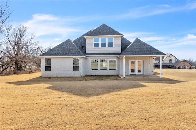 rear view of house with a yard and a patio