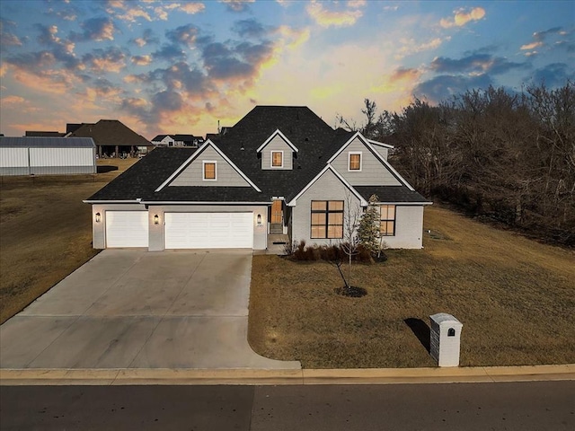 view of front of property featuring a garage and a lawn