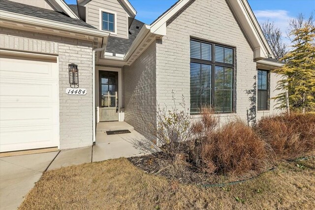 doorway to property with a garage