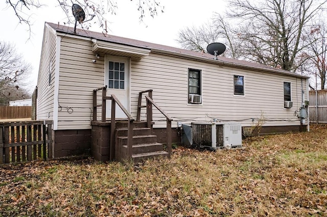 rear view of property with central AC unit