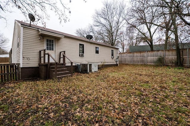 rear view of house featuring central air condition unit