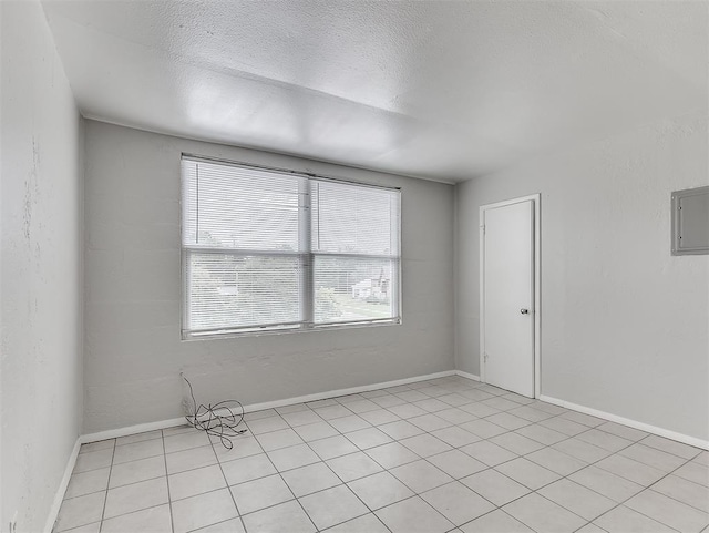 unfurnished room featuring a textured ceiling