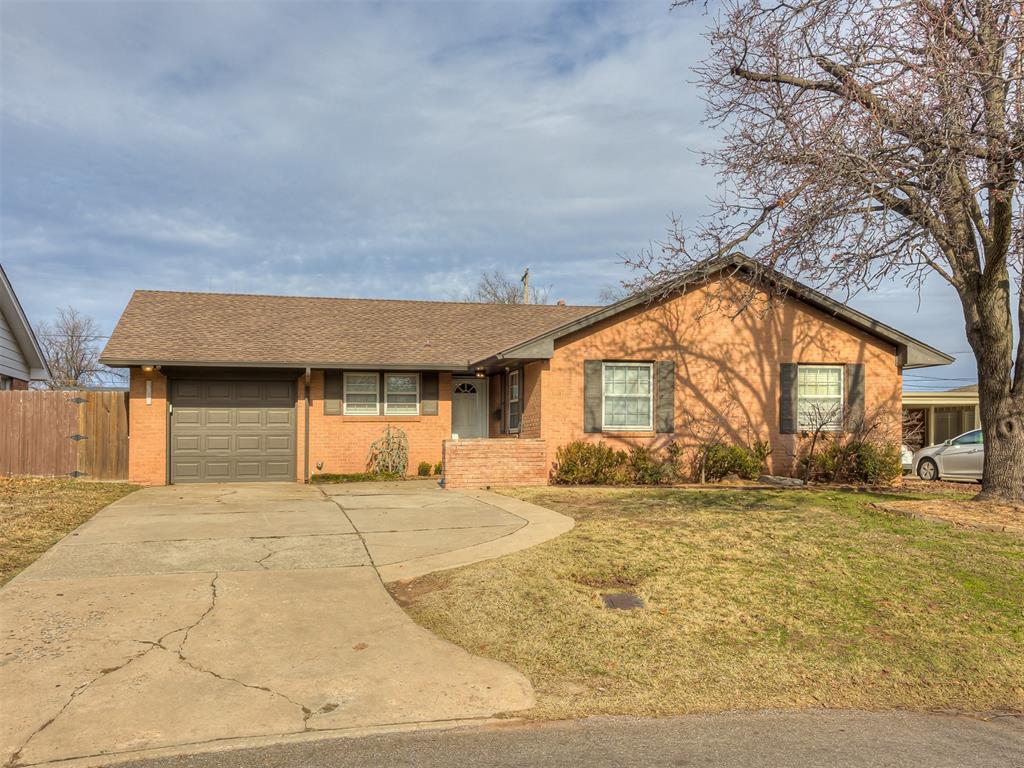 ranch-style house featuring a front yard and a garage