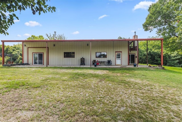 back of house with a lawn