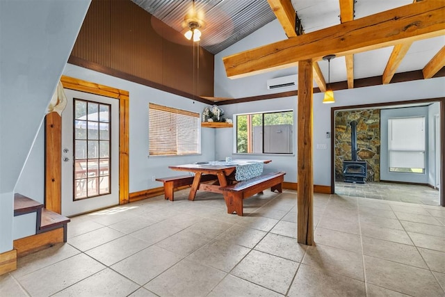 49900 W 201st St, Depew, OK 74028 - dining room featuring light tile patterned floors, a wall unit AC, a wood stove, stairs, and a ceiling fan