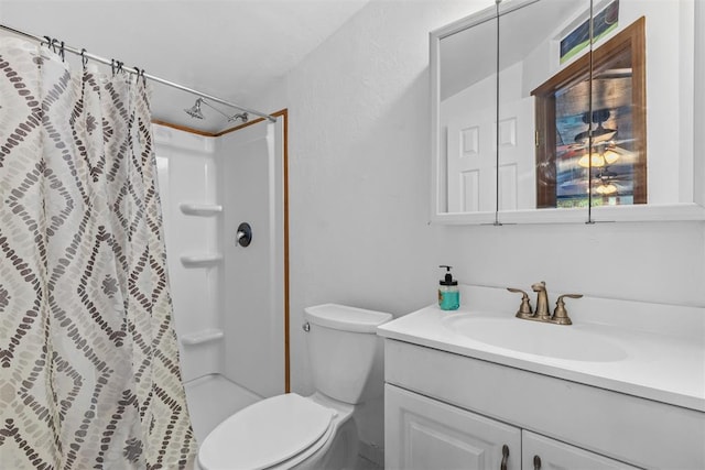 bathroom featuring toilet, vanity, and a shower with shower curtain