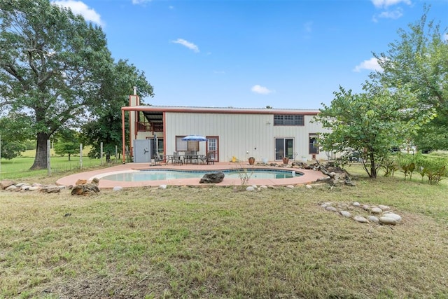 49900 W 201st St, Depew, OK 74028 - back of property with a lawn, an outdoor pool, a chimney, a patio area, and a metal roof