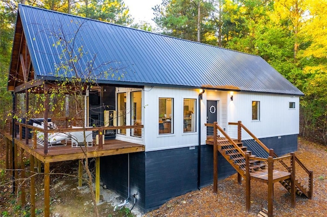 back of property featuring a wooden deck