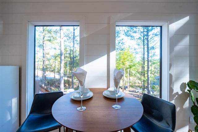 dining room featuring wooden walls