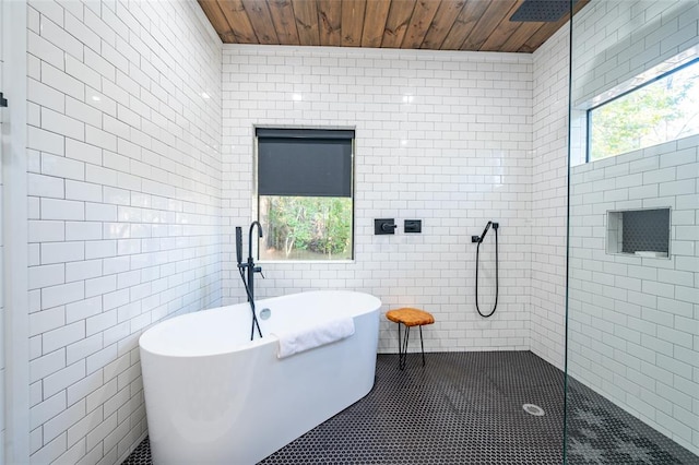 bathroom with tile patterned floors, shower with separate bathtub, wooden ceiling, and tile walls