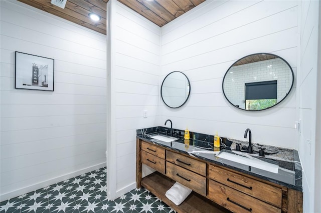 bathroom featuring wooden walls, vanity, and wooden ceiling