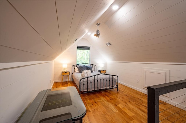 bedroom with hardwood / wood-style flooring and vaulted ceiling