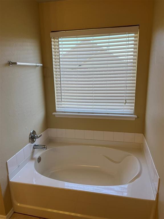 bathroom featuring a tub to relax in