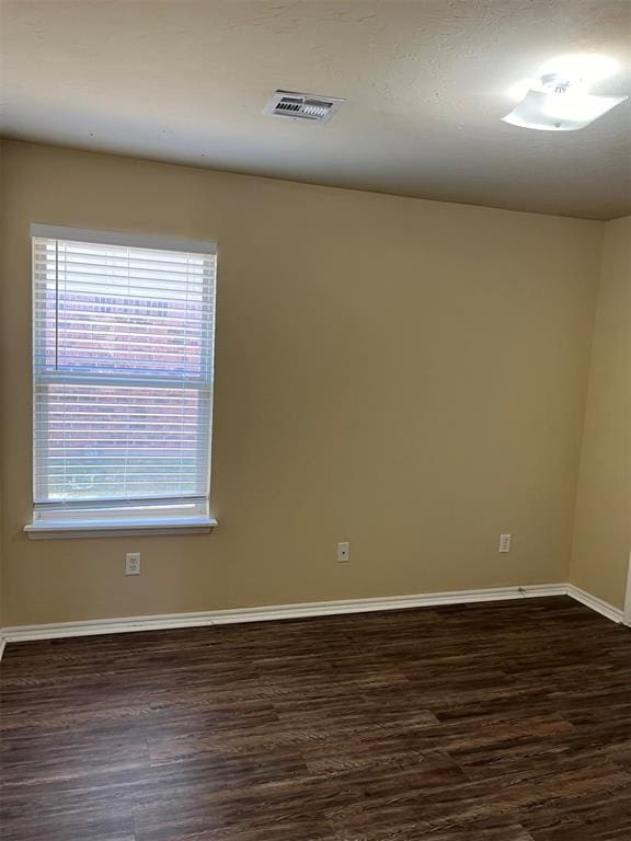 empty room featuring dark hardwood / wood-style floors