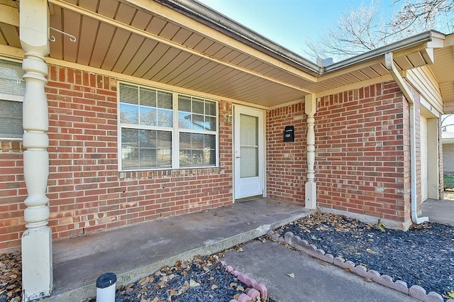 view of exterior entry featuring covered porch