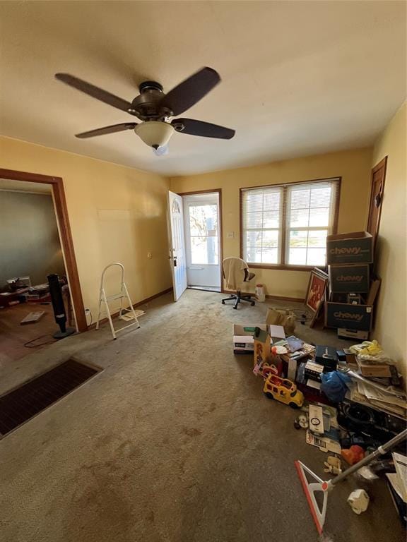 miscellaneous room with ceiling fan and light carpet