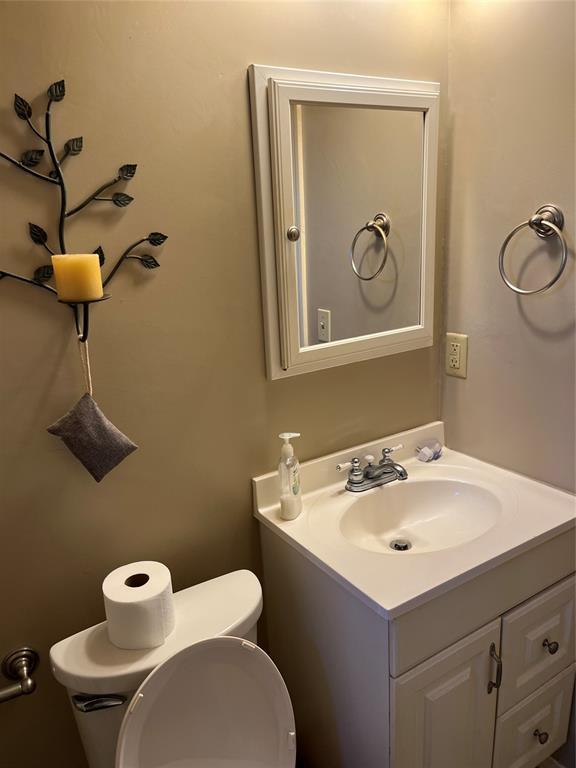 bathroom featuring toilet and vanity