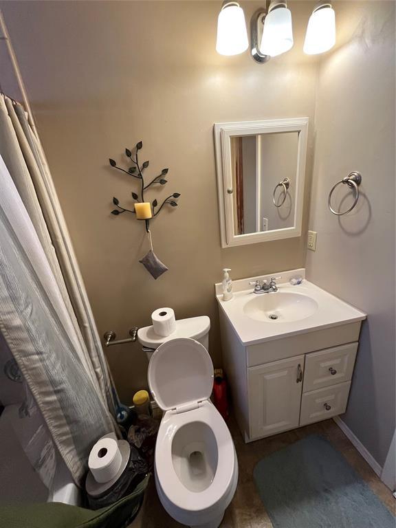 bathroom featuring toilet and vanity