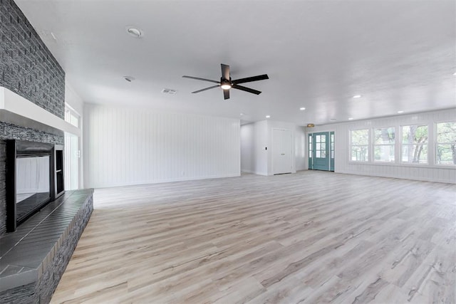 unfurnished living room featuring ceiling fan and light hardwood / wood-style floors