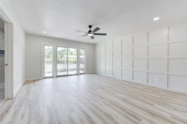 empty room with light hardwood / wood-style floors and ceiling fan