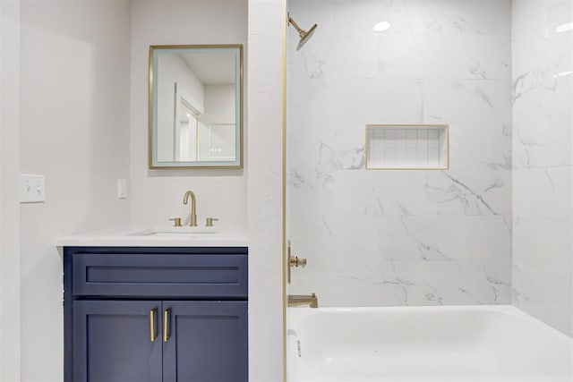 bathroom featuring vanity and tiled shower / bath