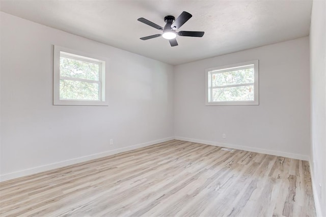 spare room featuring light wood-type flooring and ceiling fan