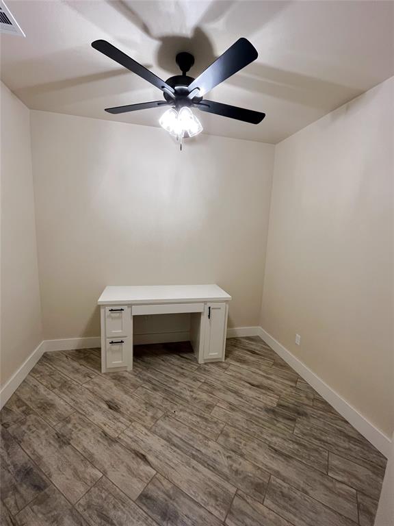 spare room featuring ceiling fan and wood-type flooring