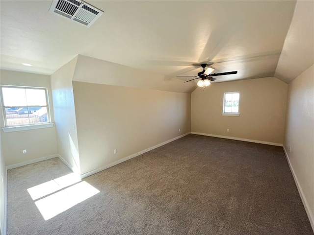 bonus room with carpet floors, ceiling fan, and lofted ceiling