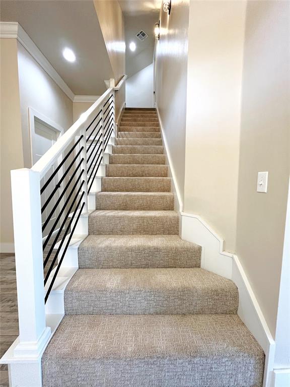 stairway with crown molding