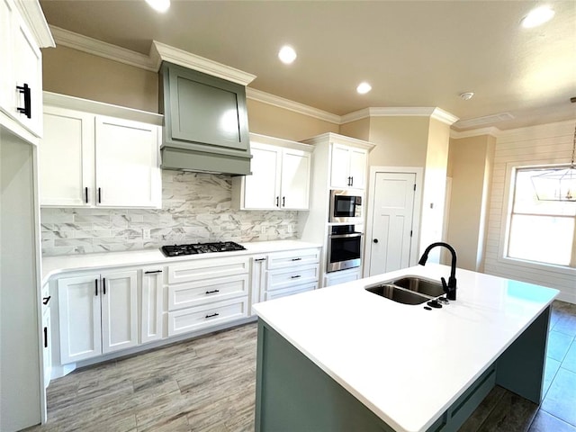 kitchen featuring sink, gas stovetop, oven, decorative backsplash, and white cabinets