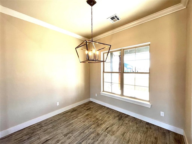 unfurnished dining area with ornamental molding, an inviting chandelier, and dark wood-type flooring