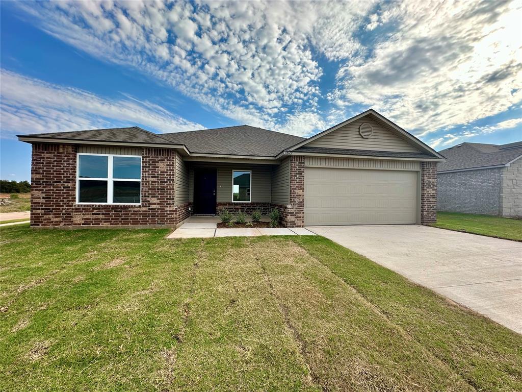 single story home with a front yard and a garage