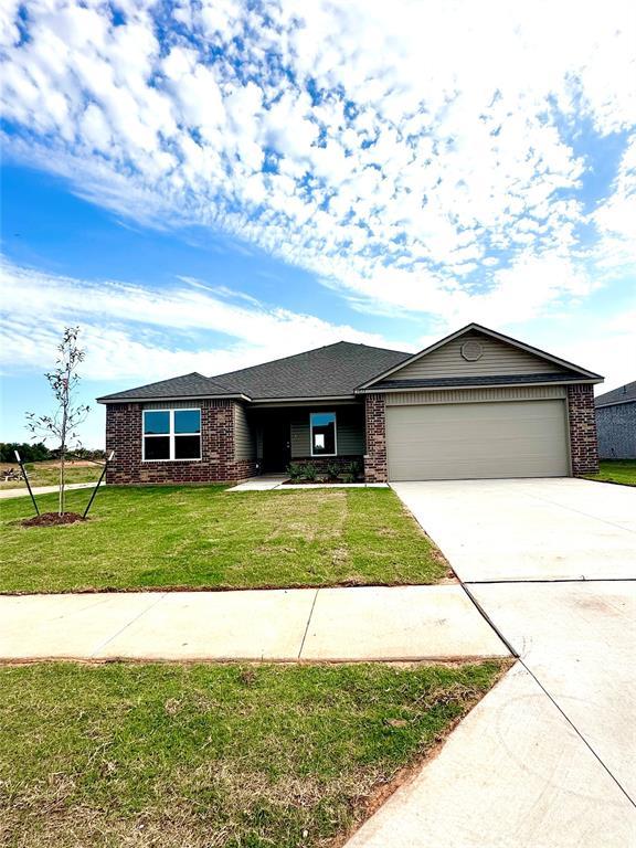 ranch-style house with a front yard and a garage