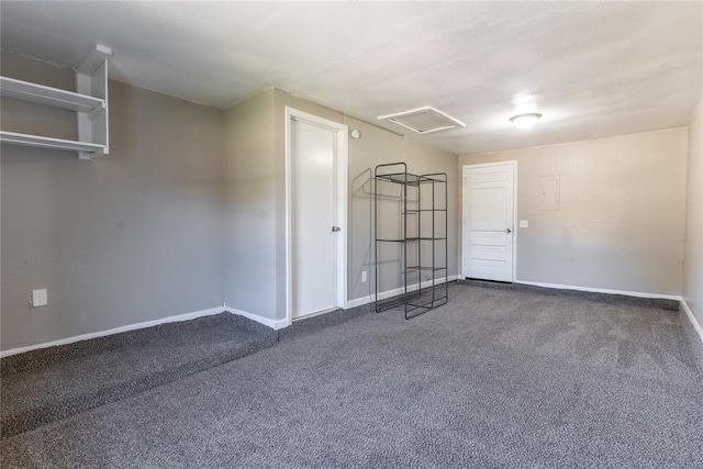 unfurnished room featuring dark colored carpet