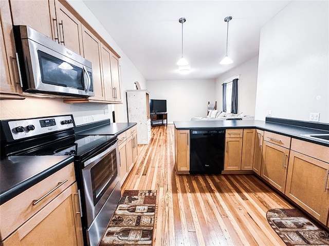 kitchen with kitchen peninsula, hanging light fixtures, appliances with stainless steel finishes, and light hardwood / wood-style flooring