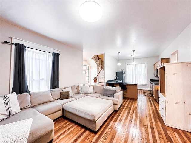 living room with sink and light wood-type flooring