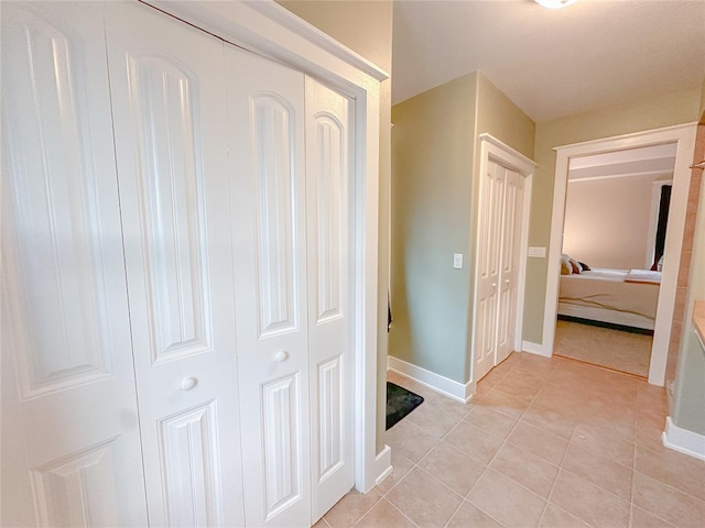 hallway with light tile patterned floors