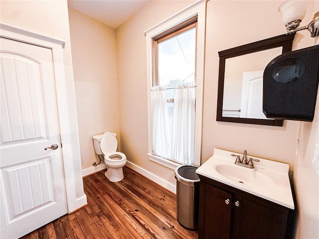 bathroom featuring hardwood / wood-style floors, vanity, and toilet