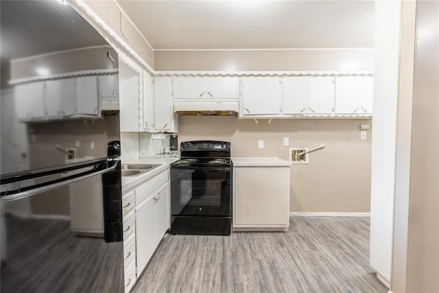 kitchen featuring black range with electric cooktop, sink, light hardwood / wood-style flooring, white cabinets, and fridge