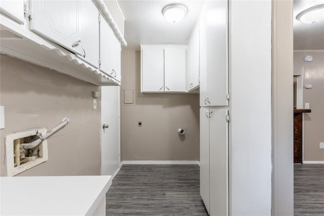 laundry room featuring cabinets, dark hardwood / wood-style flooring, and electric dryer hookup