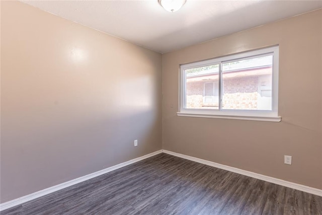 spare room featuring dark wood-type flooring